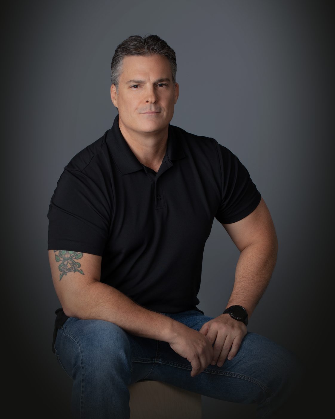 Bobby Harrington, seated, looking at the camera